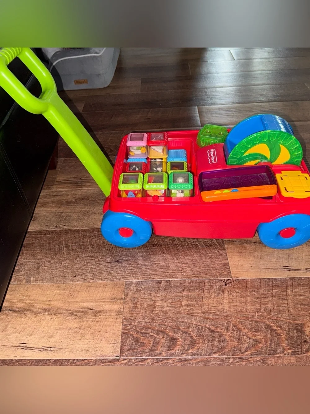 Vintage Fisher-Price Peek-a-boo Pull Toy with Green Handle and Blue Wheels